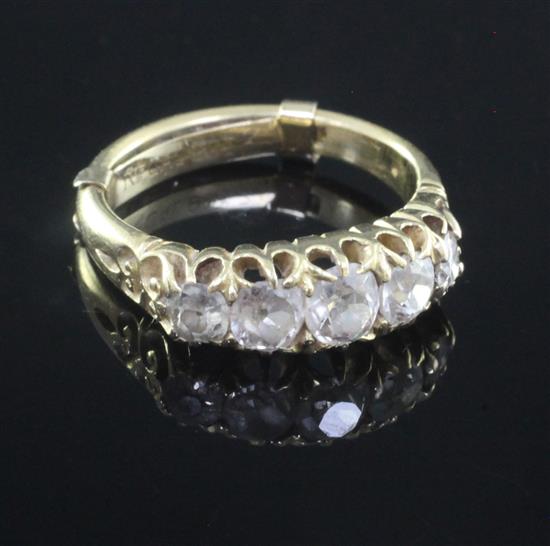 A late Victorian 18ct gold and graduated five stone diamond half hoop ring, size L.